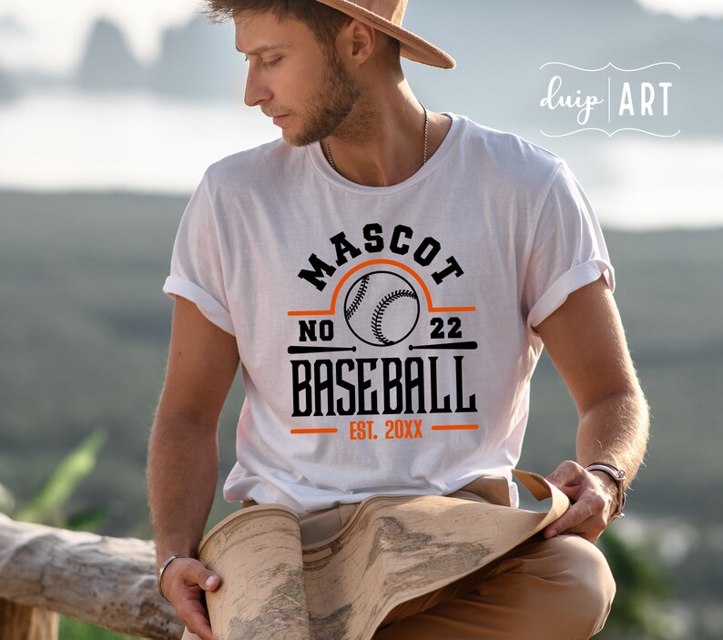 May include: White t-shirt with a black and orange baseball graphic. The graphic says "Mascot No. 22 Baseball Est. 20XX".