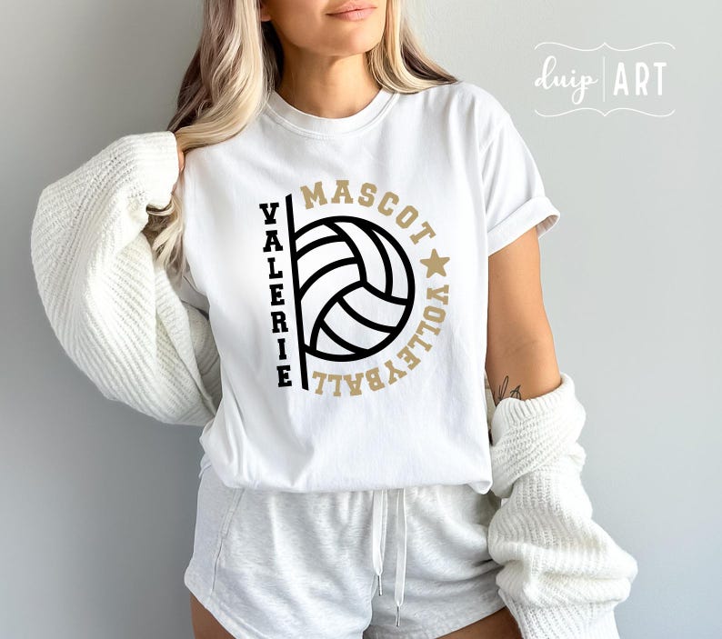 May include: White t-shirt with a volleyball graphic and the text "Valerie Mascot Volleyball" in black and gold lettering.