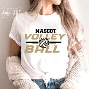 May include: White t-shirt with a gold and black graphic that says "Mascot Volleyball" with a volleyball graphic in the center.