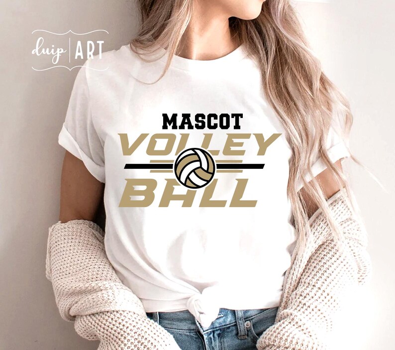 May include: White t-shirt with a gold and black graphic that says "Mascot Volleyball" with a volleyball graphic in the center.