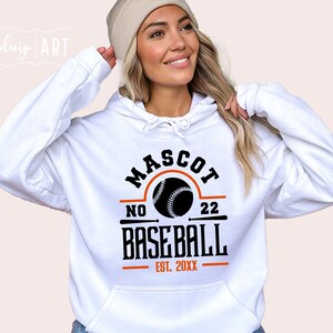 May include: White hooded sweatshirt with the text "MASCOT NO 22 BASEBALL EST. 20XX" and a baseball graphic.