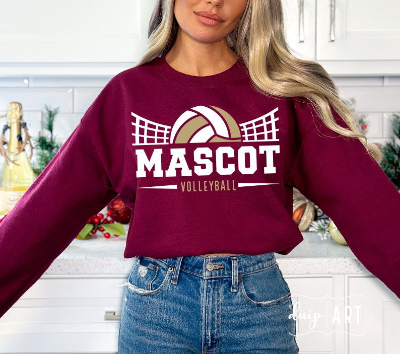 May include: Burgundy sweatshirt with a white volleyball graphic and the text "MASCOT VOLLEYBALL".