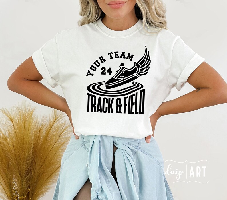 May include: White t-shirt with black text and graphic. The text reads "Your Team 24 Track & Field" and the graphic is a black sneaker with wings.