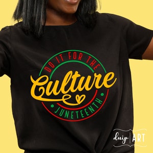 May include: Black t-shirt featuring a red, green and yellow circular design. The circle reads "Do it for the Culture Juneteenth" with a heart in the centre.