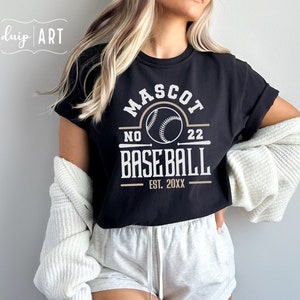 May include: Black t-shirt with a white graphic design that says "Mascot No. 22 Baseball Est. 20XX". The graphic includes a baseball and two crossed bats.
