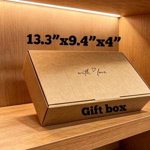 May include: A rectangular brown cardboard gift box with the text "with love" and a heart symbol printed on the lid, and the words "Gift box" on the front side. The box dimensions are clearly printed as 33.8 cm by 23.9 cm by 10.2 cm.