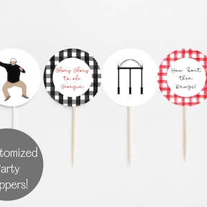 May include: Four white, round party toppers with different designs. One shows a person with headphones, another has a black and white checkered pattern with text, and two others have red checkered patterns with text. The text reads "Glory Glory to ole Georgia" and "How 'bout them Dawgs!"