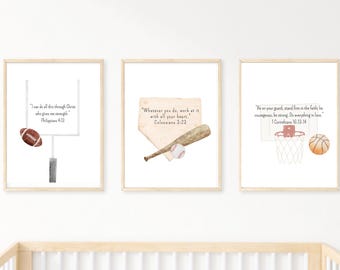 May include: Three framed prints with watercolor illustrations of sports equipment and Bible verses. The prints feature a football and goalpost, a baseball bat and ball, and a basketball and hoop. The text includes Philippians 4:13, Colossians 3:23, and 1 Corinthians 16:13-14.