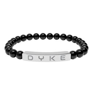 May include: Black beaded bracelet with a silver bar featuring the word "DYKE". The bracelet is made of round, glossy black beads strung together. The silver bar is curved and has the letters etched into it.