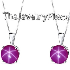 May include: Two silver necklaces with a pink star-shaped gemstone pendant. The necklaces are on a white background.
