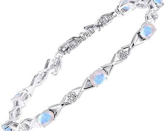 Puede incluir: Una pulsera de plata con un diseño delicado que presenta piedras de ópalo ovaladas y pequeñas piedras redondas transparentes. La pulsera tiene un patrón de cruz y está acentuada con el texto "The Jewelry Place".