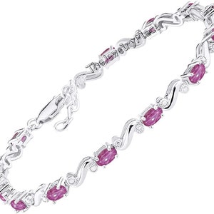 May include: A silver bracelet with a wavy design and pink oval-shaped gemstones. The bracelet has a clasp closure.