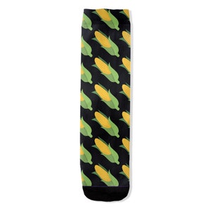 May include: Black socks with a repeating pattern of yellow corn on the cob with green husks.