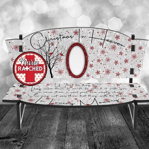 May include: A white wooden bench with a red and white circle that says "Nurse Ratched" and a red cardinal on a tree branch. The bench has a white background with a red glitter snowflake pattern. The text "Christmas in Heaven" is written in red cursive on the top of the bench. The bench has a photo frame in the center.