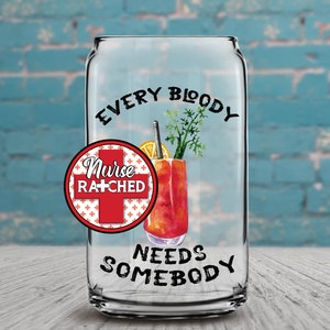 May include: A clear glass can with the text "Every Bloody Nurse Ratched Needs Somebody" printed on it. The can has a red and white circle with a cross and the text "Nurse Ratched" inside. There is a drawing of a bloody mary cocktail inside the can.