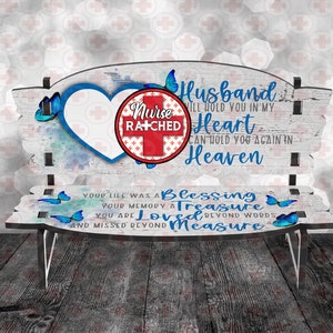 May include: A white wooden bench with blue butterflies and a red heart with the words "Nurse Ratched" on it. The bench has the words "Husband I'll hold you in my heart Can hold you again in Heaven Your life was a Blessing Your memory a Treasure You are Loved beyond words and missed beyond Measure" on it.