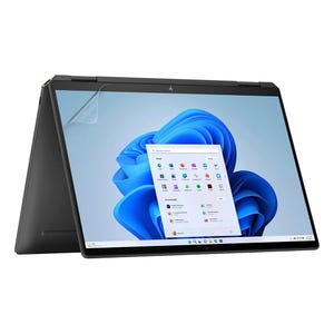 May include: A black laptop computer with a silver HP logo on the lid. The screen is open and displaying the Windows 11 operating system. The screen is showing a blue and white abstract background with a search bar and a list of apps.