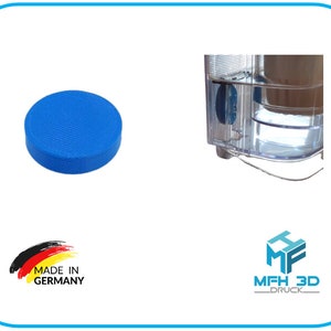Könnte beinhalten: Eine blaue, 3D-gedruckte runde Scheibe mit einer strukturierten Oberfläche. Die Scheibe ist in Deutschland hergestellt. Das Bild zeigt auch einen durchsichtigen Plastikbehälter mit einer blauen Scheibe darin.