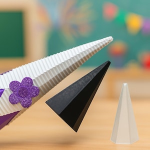 May include: A purple, white, and black geometric paper craft with a flower accent. The craft has a white, textured, triangular top and a black triangular shape. A white cone is also present.