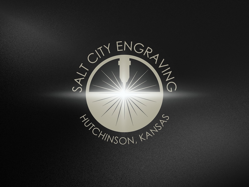 May include: A white logo on a black background with the text "Salt City Engraving" in a circle around a laser beam graphic. The text "Hutchinson, Kansas" is below the circle.