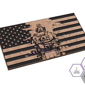May include: A laser cut wooden design of an American flag with a soldier standing in front of it. The flag is distressed and the soldier is holding a rifle.
