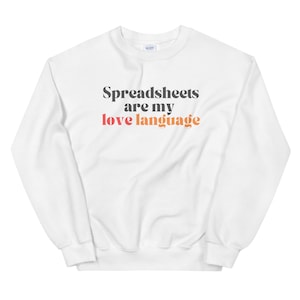 May include: White sweatshirt with the text "Spreadsheets are my love language" in black, red, and orange. The crew neck sweatshirt is a casual style.