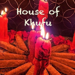 May include: A close-up of a red candle with a black design, surrounded by rolled-up brown cigars. The candles are lit and the text "House of Khufu" is written in white on a dark background.