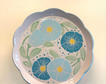 Scalloped dinner plate with turquoise and mint flowers with leaves swirling