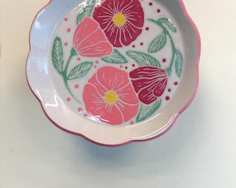 Scalloped side or salad plate with red and pink flowers with leaves swirling