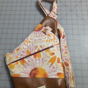 Right shoulder, gold/rust fall leaves, tribal and sunflower print with brown vinyl.