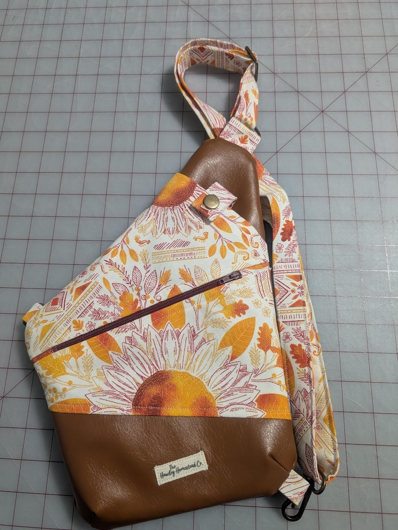 Right shoulder, gold/rust fall leaves, tribal and sunflower print with brown vinyl.
