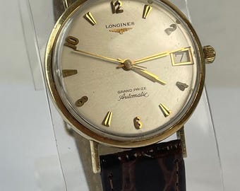 Longines Grand Prize Automático, chapado en oro de 10 quilates, fecha, esfera plateada, vintage, fabricado en Suiza en 1962.