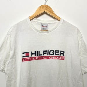 Vintage 1990s Tommy Hilfiger Athletic Gear Spell Out Flag Logo made in USA Graphic Tee Shirt (size adult Medium)