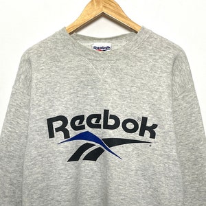 Vintage 1990s Reebok Spell Out Delta Logo Graphic Pullover Crewneck Sweatshirt (size adult Medium)