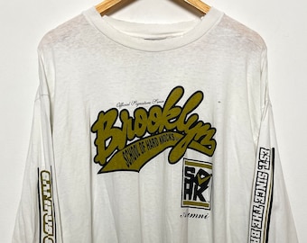 Vintage 1990s School of Hard Knocks Campus Collection Brooklyn New York Alumni Spell Out made in USA Graphic Long Sleeve Tee Shirt (size XL)