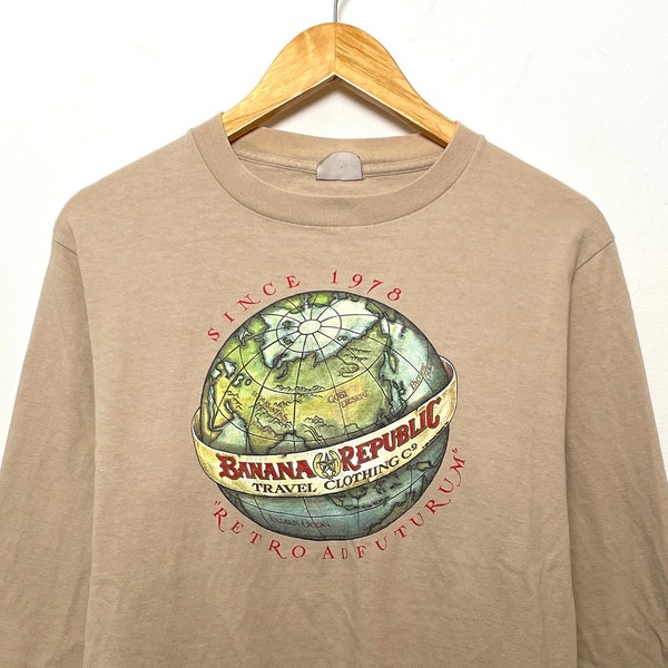 Vintage 1990s Banana Republic Travel Clothing Co "Retro Ad Futurum" Spell Out Globe Graphic Beige Long Sleeve Tee Shirt (size adult Medium)