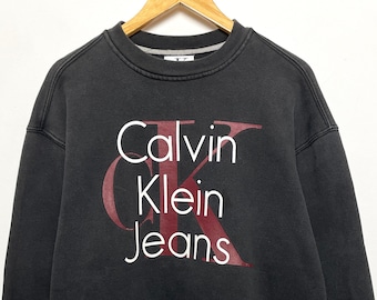 Vintage 1990s Calvin Klein Jeans Spell Out Logo Graphic Crewneck Pullover Sweatshirt (size adult XL)