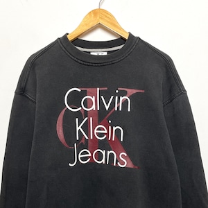 Vintage 1990s Calvin Klein Jeans Spell Out Logo Graphic Crewneck Pullover Sweatshirt (size adult XL)