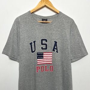 Vintage 1990s Polo Sort by Ralph Lauren USA Flag Logo Spell Out Graphic Tee Shirt (size adult Medium)
