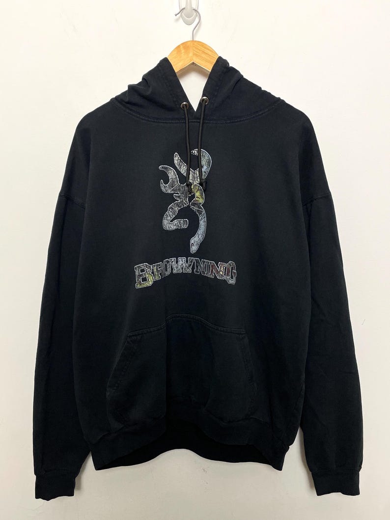 May include: Black hooded sweatshirt with a camouflage Browning logo and the word "Browning" in white lettering.