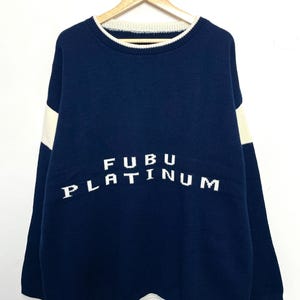 Vintage 1990s FUBU Platinum Spell Out Graphic Knit Ringer Crewneck Sweater (size adult XXL)