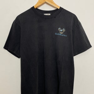 May include: Black t-shirt with a faded Mickey Mouse graphic and the text "Walt Disney World" printed on the front.