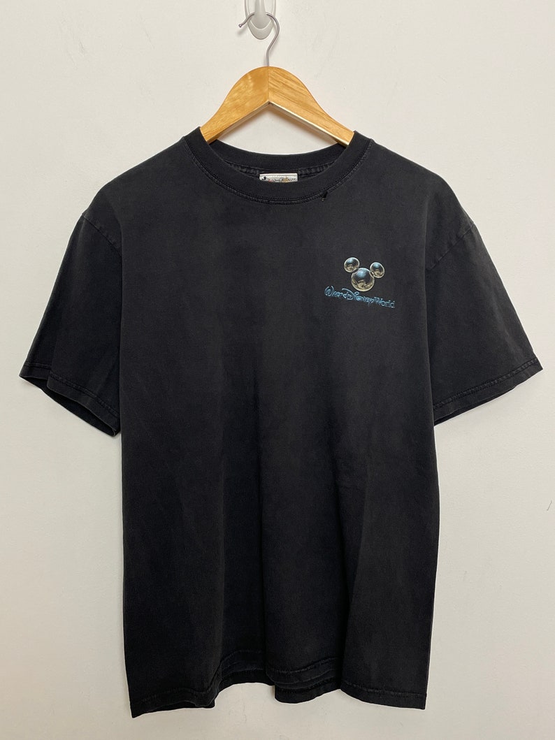 May include: Black t-shirt with a faded Mickey Mouse graphic and the text "Walt Disney World" printed on the front.