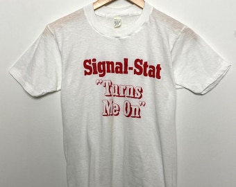 Vintage 1980s Signal Stat “Turns Me On” Spell Out Graphic Tee Shirt (fits adult XS)