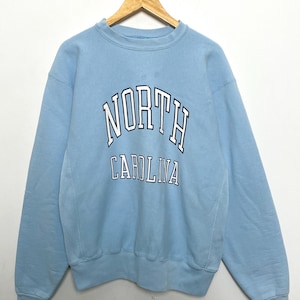 Vintage 1990s Champion Reverse Weave University of North Carolina Tar Heels Spell Out Graphic Blue College Crewneck Sweatshirt (size Large)