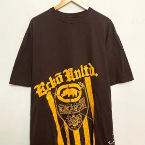Vintage 2000s Ecko Unlimited Brown and Yellow Spell Out Rhino Graphic Tee Shirt (fits size adult XXL)