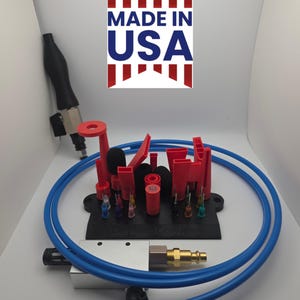 May include: A selection of red, black, and silver tools and components, including nozzles, fittings, and a blue hose. The image also features a "MADE IN USA" graphic.