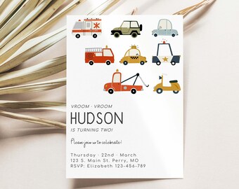 May include: A white invitation card with a colorful illustration of various vehicles, including a fire truck, ambulance, police car, taxi, and a tow truck. The text on the card reads "VROOM VROOM HUDSON IS TURNING TWO! Please join us to celebrate! Thursday, 22nd March 123 S. Main St. Perry, MO RSVP: Elizabeth 123-456-789"