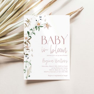 May include: A baby shower invitation with a floral design and the text "BABY in bloom" in pink. The invitation includes the name "Regina Walters" and details for the shower, including the date, time, location, and RSVP information.