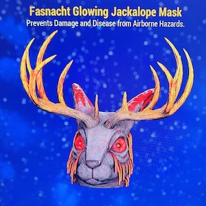 May include: A Fasnacht Glowing Jackalope Mask with large, golden antlers and red eyes. The mask has a rabbit-like face with orange accents and the text "Prevents Damage and Disease from Airborne Hazards."